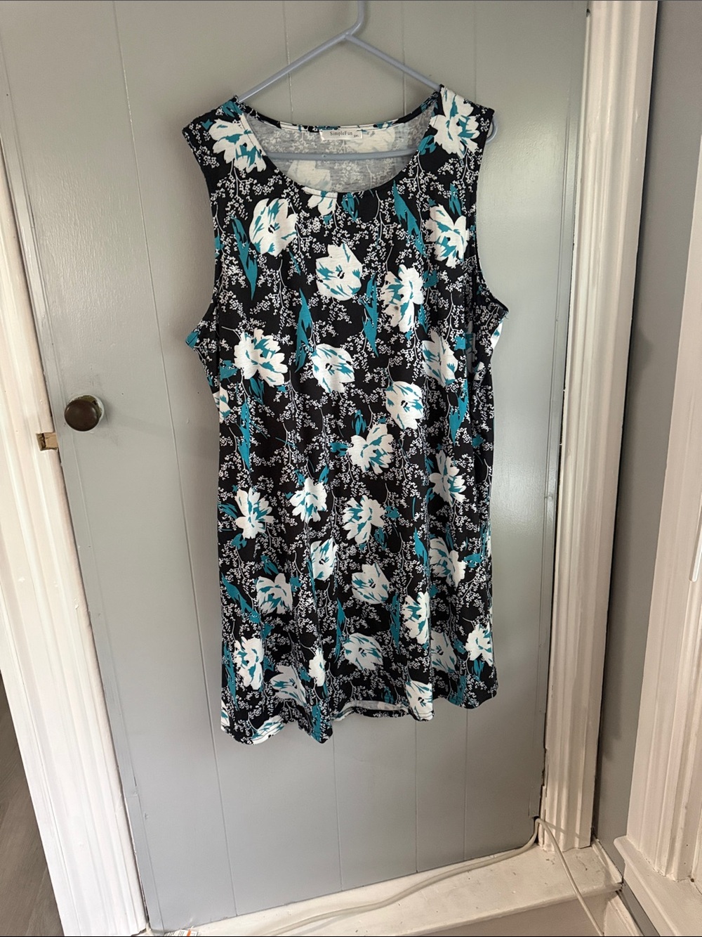 Sleeveless women’s sun dress with pockets. Black with white and turquoise flow
